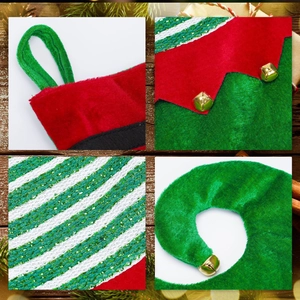 Christmas elf stocking with bells and red green plush fabric on wooden background