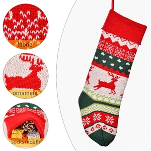 Knitted Christmas stocking with red reindeer and snowflake patterns for holiday home decor