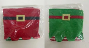 Close-up of red and green velvet Christmas elf socks with gold buckles in packaging
