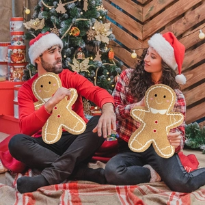 Christmas gingerbread man plush pillow with cute embroidery shown in festive setting