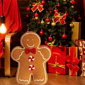 Close-up of plush gingerbread man pillow with teddy fleece texture and festive bow
