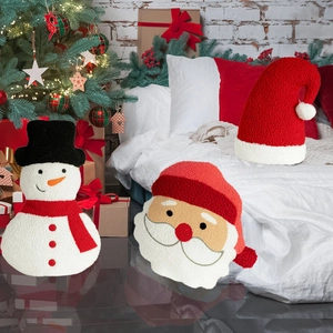 Christmas themed plush throw pillows in snowman and Santa Claus designs for holiday home decor