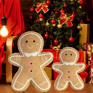 Close-up of ginger man plush pillows with festive embroidery and red pom-pom buttons