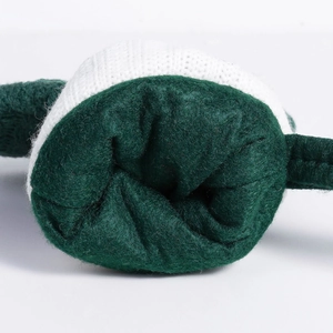 Close-up of small green knit Christmas stocking with white wool texture and fleece lining