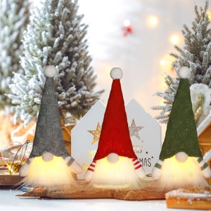 Three-piece set of glowing Christmas gnomes with warm LED lights and knitted hats