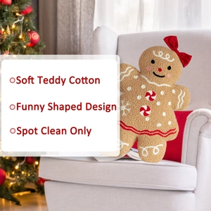 Detail of soft teddy cotton ginger bread man plush pillow with red bow on a white sofa
