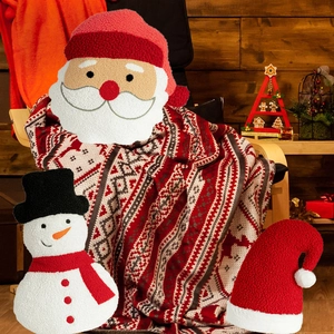 Close-up of Santa, snowman and Christmas hat plush pillows in soft sherpa fabric