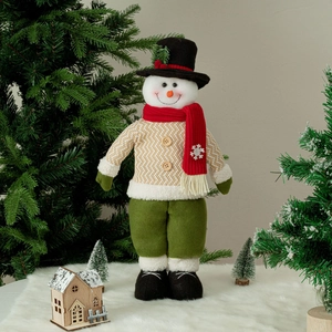Charming Christmas snowman figurine with a black top hat and red scarf in a cozy winter setting
