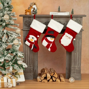 Three-piece Christmas stocking set with Santa, snowman and penguin on vintage mantel