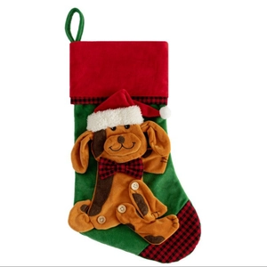 Christmas pet stocking with green velvet body and plush dog ornament in festive red trim