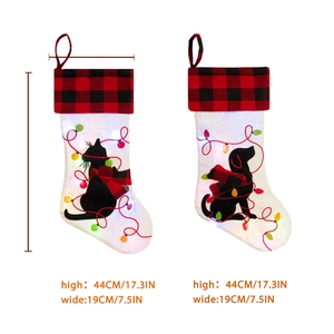 Red plaid Christmas stocking with glowing LED lights and cat dog silhouettes