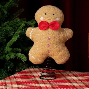 Detail of plush gingerbread man tree topper with red bowtie and spring base stand