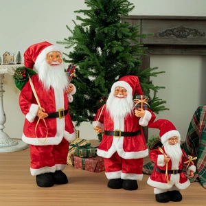 Three telescopic Santa Claus figures in classic red velvet standing in a festive home setting
