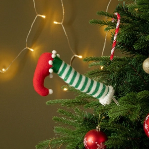 Christmas tree branch elf legs decoration with red felt boots and green striped stockings