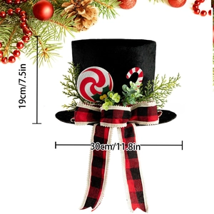 Christmas tree topper black top hat with red bow and peppermint candy decorations