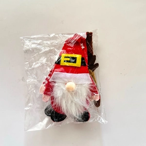 Detail of Christmas gnome cutlery holder with red hat, white beard, and reindeer antlers