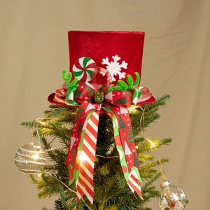 Detail of red velvet Christmas tree topper hat with colorful ribbons and festive ornaments
