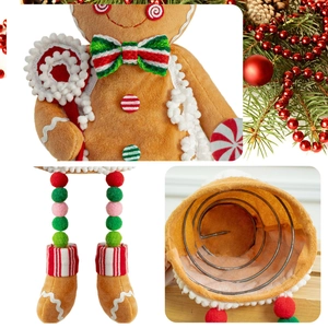 Detail view of plush gingerbread man with Christmas striped bowtie and metal spring base