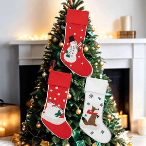 Christmas stockings set with embroidered snowman and fox hanging on a festive Xmas tree