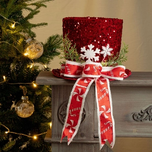 Detail of red sequined Christmas tree topper hat with snowflake felt and festive ribbons