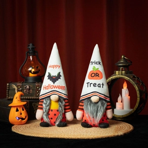 Detail of Halloween gnome plush dolls with Trick or Treat motifs and festive orange stripes