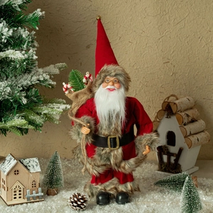 Detailed close-up of Santa Claus figure with velvet robe and gift bag in a snowy setting