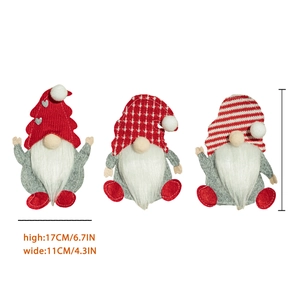 Three Christmas gnome cutlery holders in red and grey felt for holiday table decor