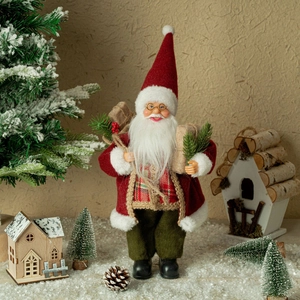Detailed Santa Claus figurine holding gifts and pine branches in a festive winter scene