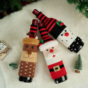 Three-piece knitted Christmas wine bottle covers with reindeer, Santa, and snowman designs