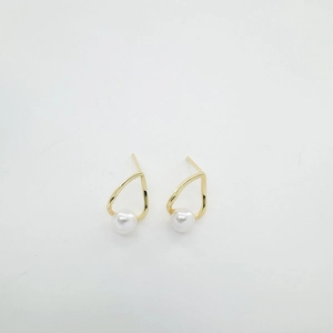 Elegant gold geometric waterdrop stud earrings with white pearl detail on white background