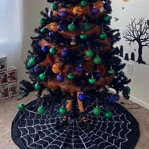 Halloween tree skirt with white spider web pattern and festive ornaments decoration