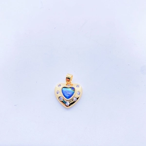 Macro view of a gold heart pendant with abalone shell inlay and zircon accents