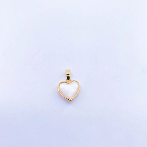 Macro shot of heart-shaped gold-framed pendant with iridescent white mother of pearl