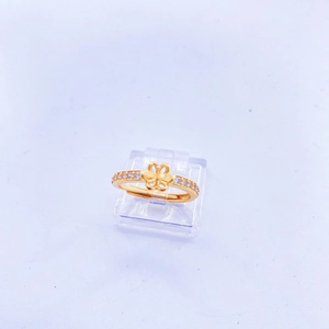 Detail of adjustable gold ring featuring a butterfly motif and side-set sparkling zircons