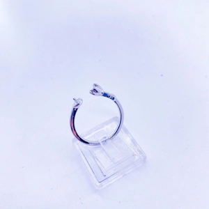 Detail of adjustable silver twist ring featuring exquisite pearl-like ends on a clear stand