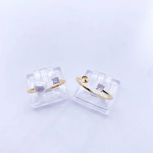 Golden open rings with purple gemstone, pearl and DIY cup setting on a white base
