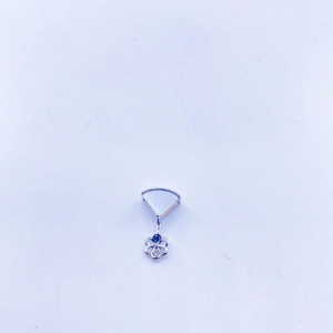 Macro detail of fan-shaped mother of pearl pendant with a blue gemstone floral drop