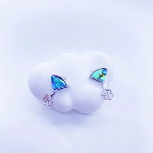 Detail of fan-shaped silver stud earrings with colorful abalone shell inlay on white cloud base