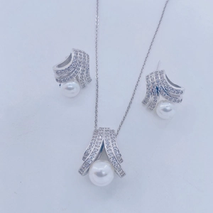 Elegant 18K silver-tone pearl jewelry set featuring a necklace and stud earrings with pavé stones