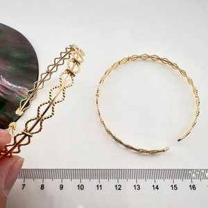 Minimalist gold wavy open cuff bracelet with double helix texture and size scale
