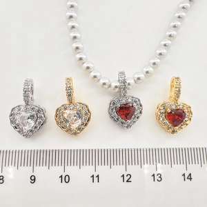 Luxurious heart zircon pendant necklaces with white pearls shown next to a ruler scale