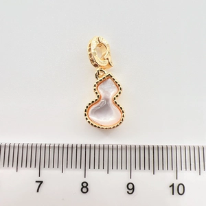 Detail of a 15mm gold-plated gourd pendant with pink mother-of-pearl and zirconia accents