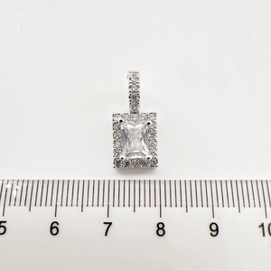 Macro view of silver geometric pendant with a large rectangular zircon and size scale