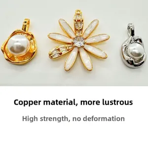 Detailed view of copper flower charms and pearl pendants for jewelry making DIY