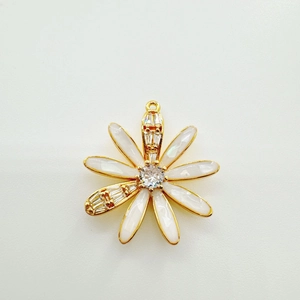 Detailed macro view of 18K gold-plated daisy flower pendant with white enamel petals