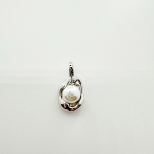 Macro view of minimalist 18K gold-plated flower tray with round white pearl