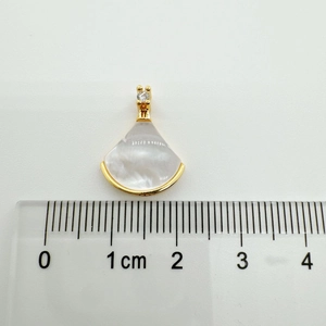 Macro shot showing 1.5cm width of 18K gold plated shell fan pendant with crystal