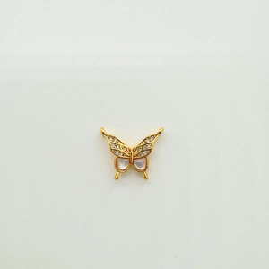 Detail van handgemaakte 18K gouden vlinderhanger met schelpinleg en zirkonia steen