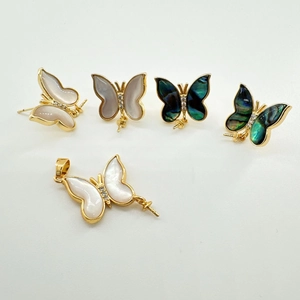 Detailed view of DIY butterfly jewelry settings with gold plating and natural shells