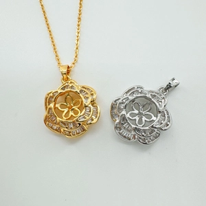 Detail of camellia flower pendants with micro-set zircons in gold and silver finishes